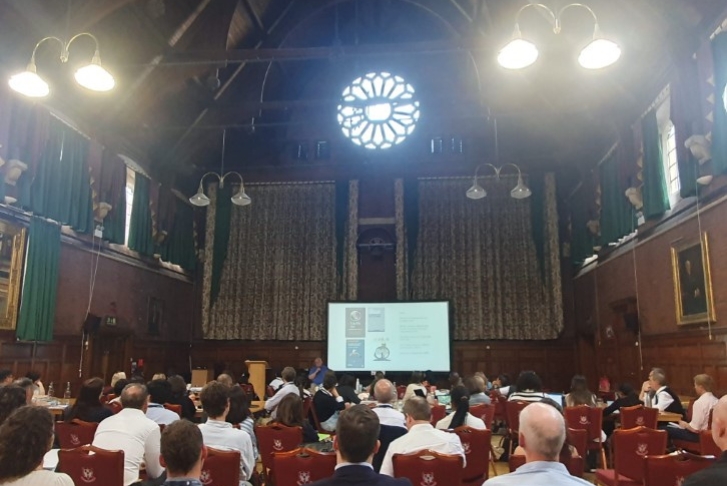 Students watching a presentation in the Great Hall at Homerton College