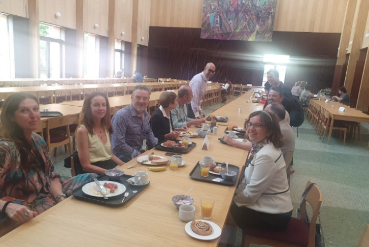 Supervisors and course directors eating breakfast on a long table