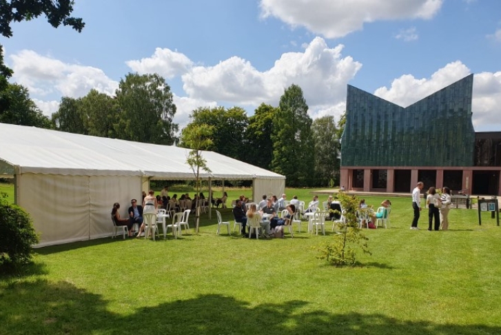 Students sat outside and in a marquee on the lawn of Homerton College PCSB workshop July 24
