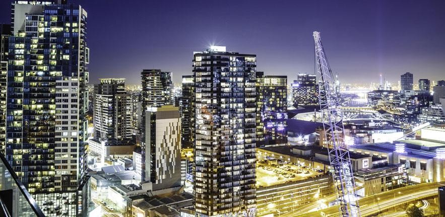 Centre for Sustainable Finance City skyline at night with skyscraper windows lit up.