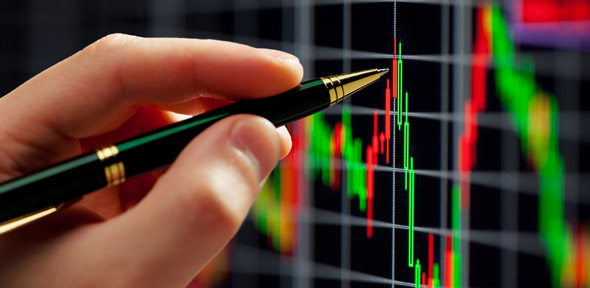 Pen pointing at stock graphs Pen pointing at stock graphs