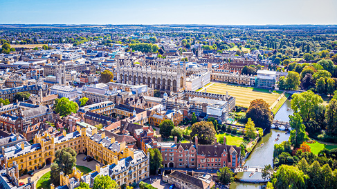 Aerial view of Cambridge featuring historic University colleges, the River Cam, green spaces and iconic architecture, showcasing a global centre for education, innovation and sustainability.