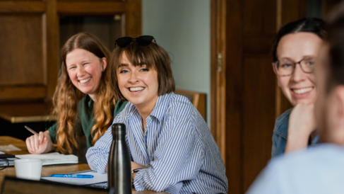 Three students smiling at the camera