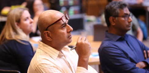 Male student looking at a presentation