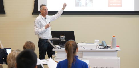 Course Director Theo Hacking presenting in front of students 