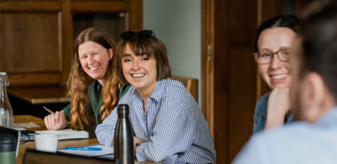 Three students smiling at the camera