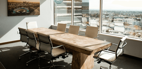 Boardroom table next to a sunny window