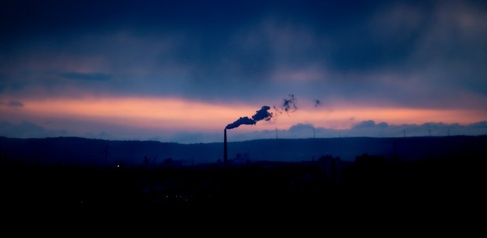 Emissions from smokestack in Germany, with dramatic sunset sky