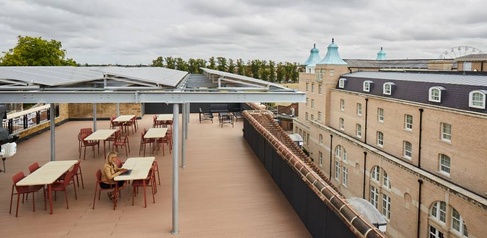 Woman working from the rooftop of the Entopia building, CISL's Headwarters and a sustainability award-winning building.