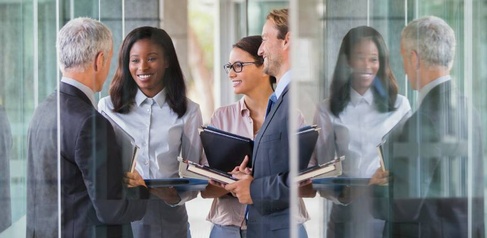 Group of business leaders meeting outside a building