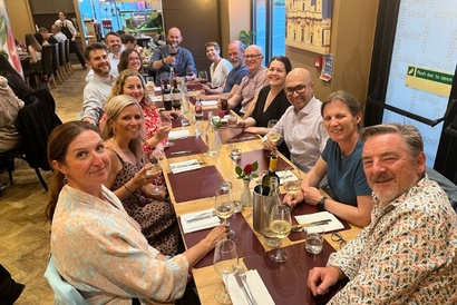 Course directors and supervisors sat at a long table in a restaurant waiting for their post workshop dinner