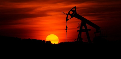 Oil pump silhouetted against sunset