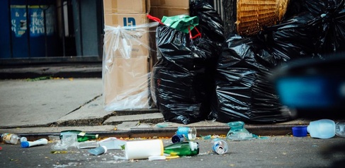 Rubbish in bags lying in the street