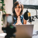 Woman in recording studio. Recording a podcast.