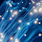A cluster of glowing blue and cyan fibre‑optic strands curves across a dark background, with bright points of light scattered along the lines to suggest fast‑moving digital signals and high‑speed data transmission.
