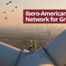 Workers inspecting wind turbine infrastructure at sunset, representing renewable energy development and the Ibero‑American Business Network for Green Growth.