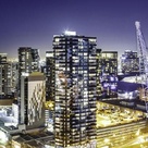 City skyline at night with skyscraper windows lit up.