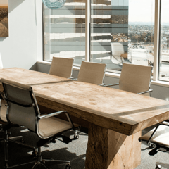 Boardroom table next to a sunny window
