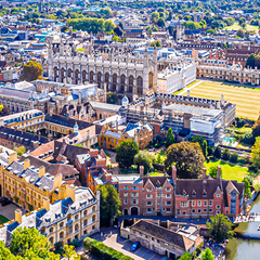 An aerial view of the Cambridge colleges and the backs in the sun.
