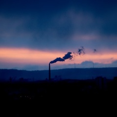 Emissions from smokestack in Germany, with dramatic sunset sky