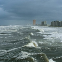 Storm clouds gathering and large waves breaking on beach in Panama City Beach, Florida, USA