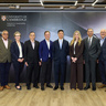 A group of ten people in professional business attire stand in front of a branded backdrop featuring the logos of Standard Chartered Global Private Bank and the University of Cambridge Institute for Sustainability Leadership, with the text “Mastery Programme Leadership and Legacy.”
