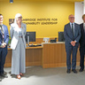 A group of people standing together for a formal photo with representatives from Minderoo and the Australian Governor‑General, all dressed in professional attire and posed in front of a branded backdrop in a well‑lit indoor setting.