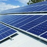 Solar photovoltaic panels mounted on a rooftop, generating renewable electricity from sunlight under a partly cloudy sky.