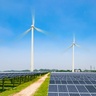 Large-scale solar farm with photovoltaic panels and wind turbines producing renewable electricity in a rural landscape.