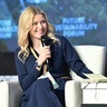 Alice Spencer speaking onstage at an event