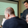Tim Forman speaking to a group of students 