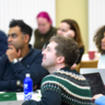 A group of mature students sat in a classroom watching a presentation. 