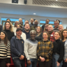 Group of Sustainable Built Environment Students standing on lecture hall steps