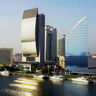 Modern waterfront skyline with several high‑rise buildings, including a curved glass tower and a triangular blue‑glass skyscraper, reflected in calm water with yachts moored in the foreground.