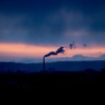 Emissions from smokestack in Germany, with dramatic sunset sky