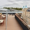 Woman working from the rooftop of the Entopia building, CISL's Headwarters and a sustainability award-winning building.