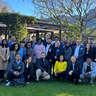 Participants of the G20 Sustainable Finance Working Group stand in a row on a grassy lawn.