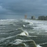 Storm clouds gathering and large waves breaking on beach in Panama City Beach, Florida, USA