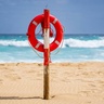 Lifebelt fixed to post on sunny beach