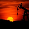Oil pump silhouetted against sunset