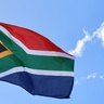 South Africa flag flying from pole, flapping in breeze