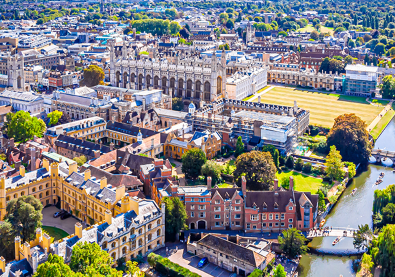 An aerial view of the Cambridge colleges and the backs in the sun.