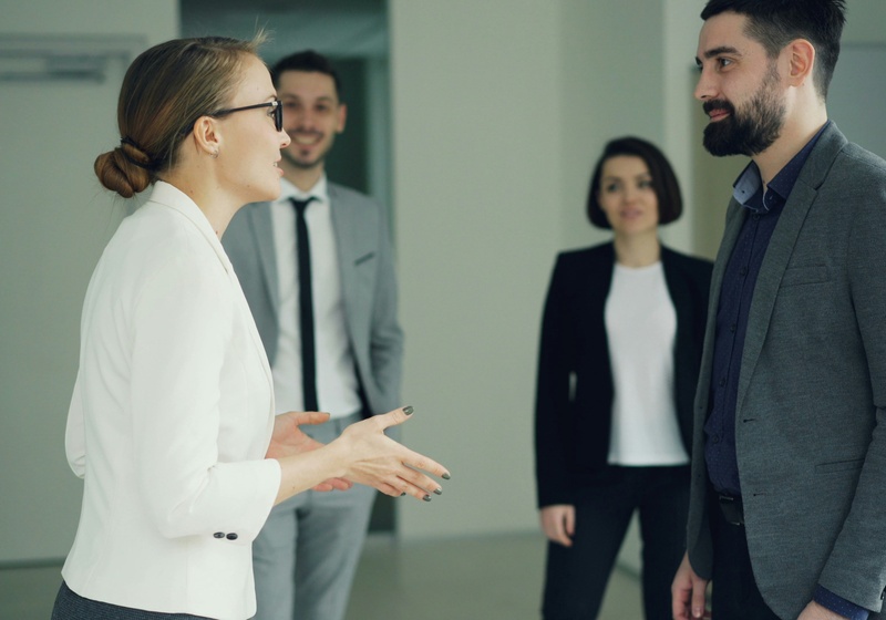 Manager speaking to a group of colleagues