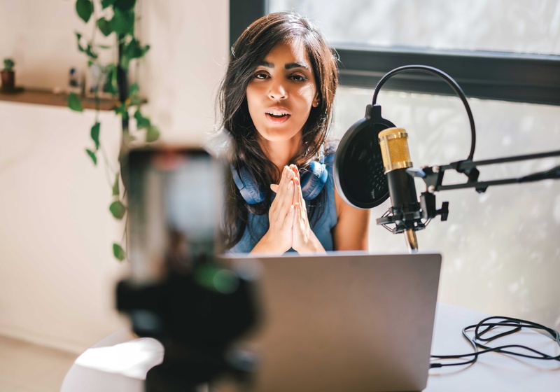 Woman in recording studio. Recording a podcast.