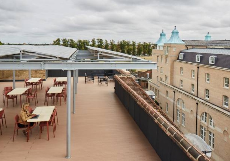Woman working from the rooftop of the Entopia building, CISL's Headwarters and a sustainability award-winning building.