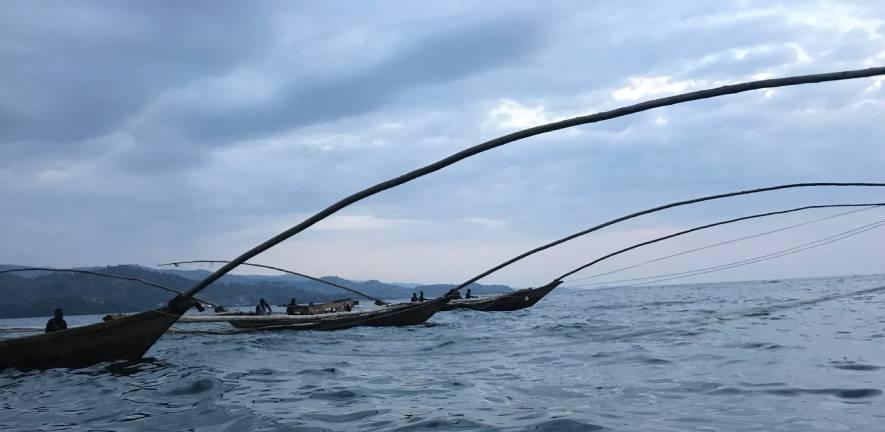 Fishermen on wooden boats. Lake Kivu, Rwanda