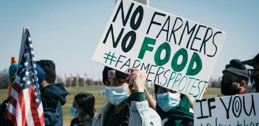 Farming protest in Washington DC. People with flags and placards saying 'No Farming No Food'