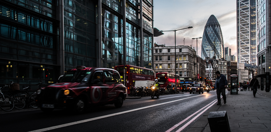 London street scene with taxi and 30 St Mary Axe, The Gherkin, on the skyline.