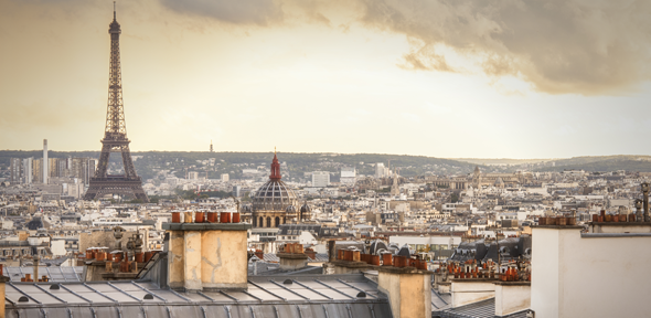 A view of the Eiffel tower and Paris skyline over rooftops